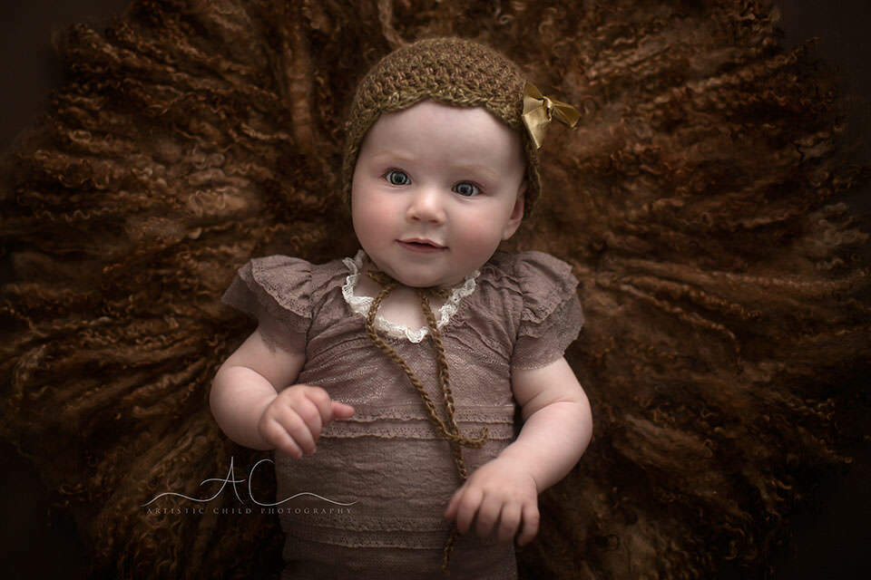 South East London Baby Photo Session | Saffron 7 portrait of 8 months old baby girl in a bow hat | London