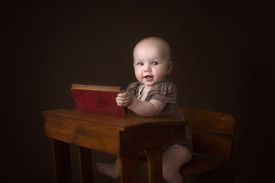 South East London Baby Photo Session | Saffron 4 baby girl playing with an old red book | London