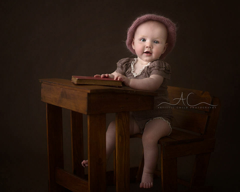 South East London Baby Photo Session | Saffron 10 8 months old baby girl sitting at a school dest | London