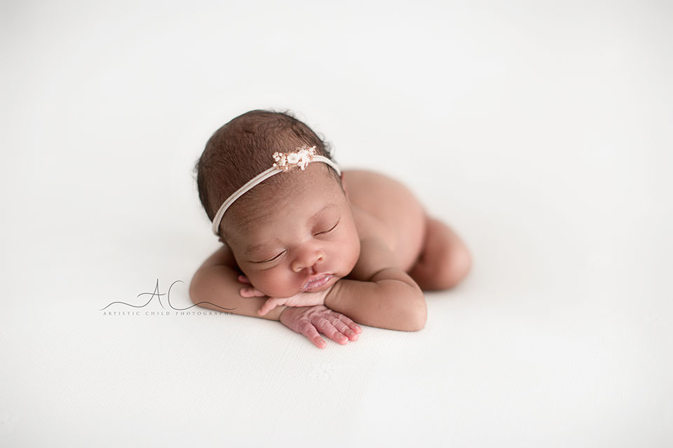 Best London Newborn Photography | Nia 6 Best London Newborn Photography | portrait of a newborn baby girl wearing a beautiful hairband