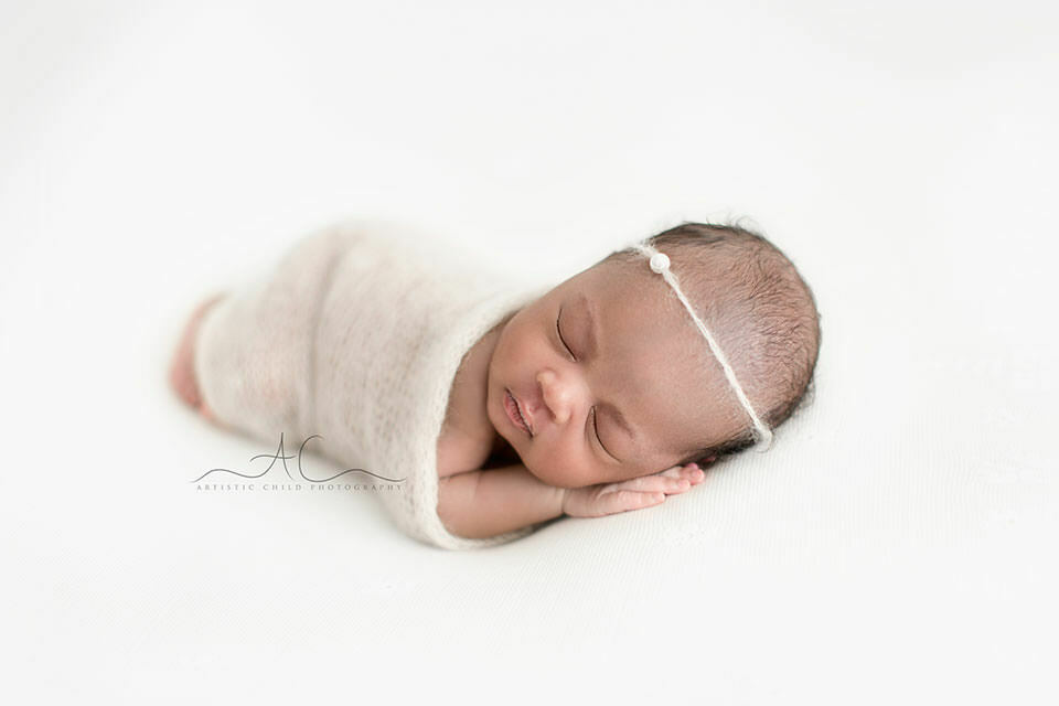 Best London Newborn Photography | Nia 8 Best London Newborn Photography | newborn baby girl sleeping wrapped in delicate crochet fabric