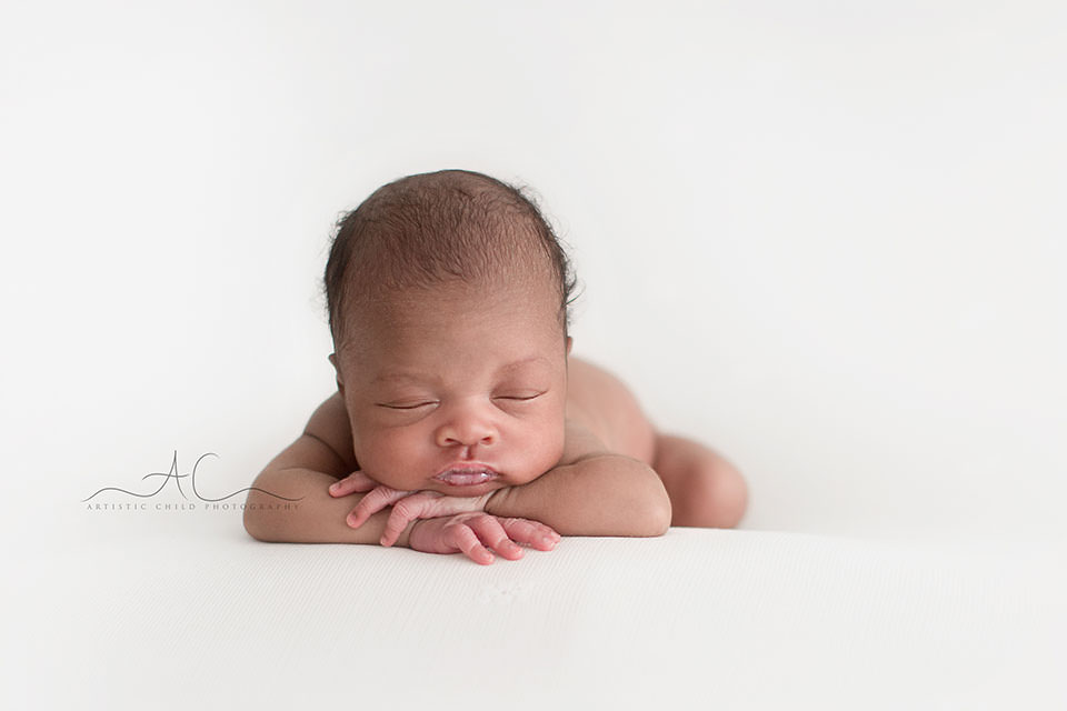 Best London Newborn Photography | Nia 3 portrait of newborn baby girl in hands under chin pose | London