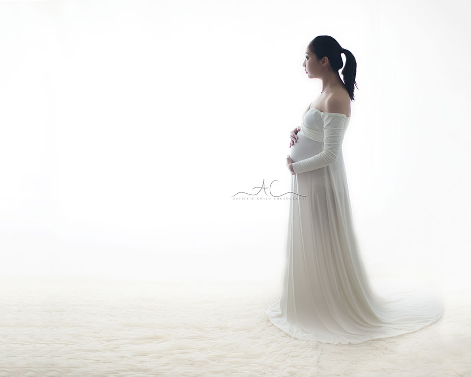South East London Pregnancy Photographer | Phoebe 3 South East London Pregnancy Photographer | pregnant woman touching her belly while looking far ahead
