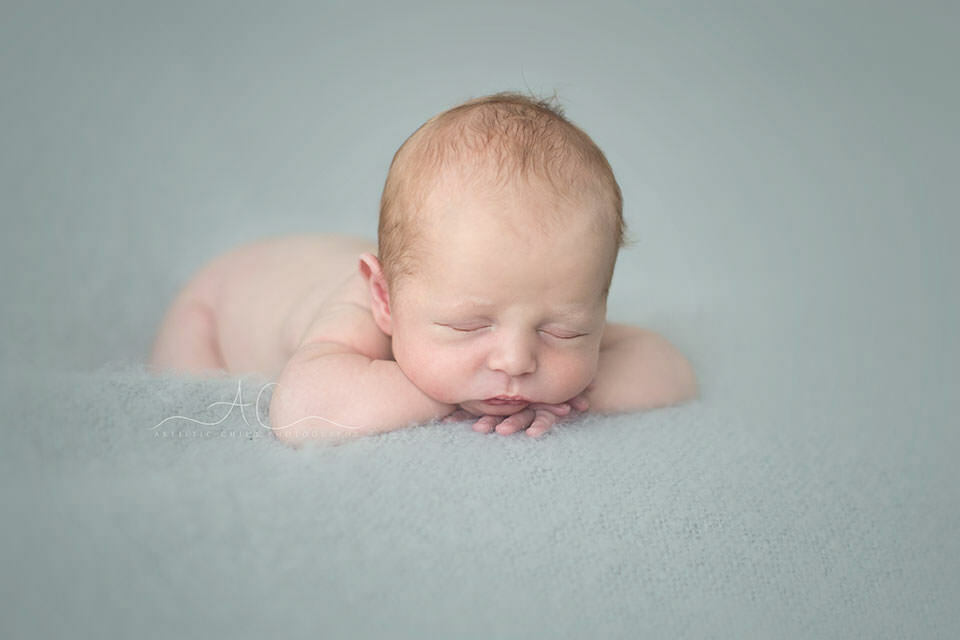 Beautiful London Newborn Images | Bay 6 newborn baby boy in hands under chin pose | London