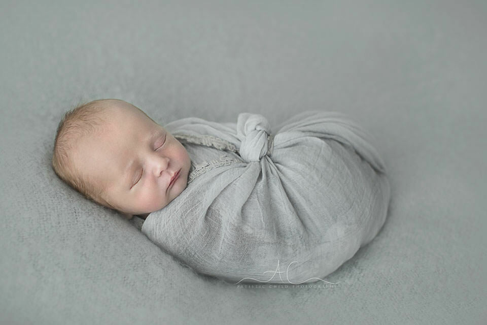 Beautiful London Newborn Images | Bay 3 Beautiful London Newborn Images | newborn baby boy wrapped with grey fabric