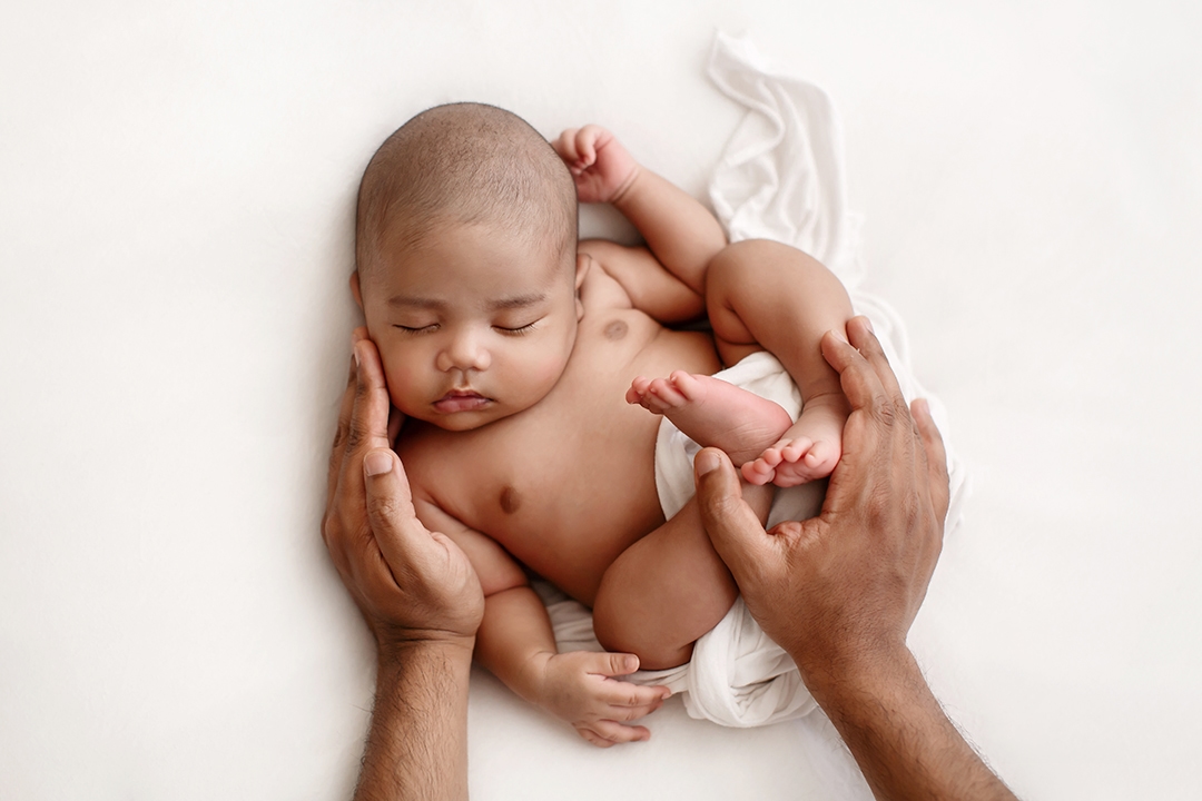 Bromley Newborn Photo Session | newborn baby boy sleeping in Dad's hands