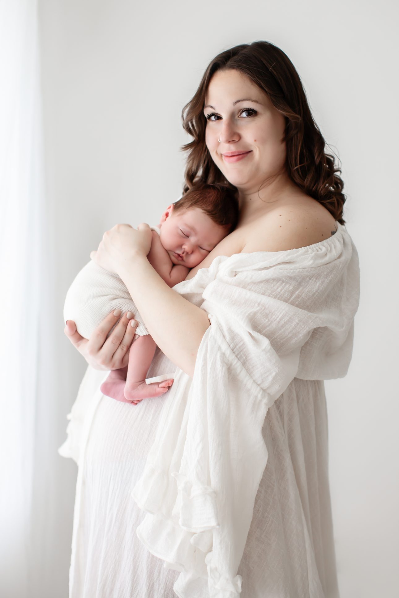 Bromley Newborn Photography | a classic portrait of mum cuddling with her newborn baby boy during a newborn photoshoot in Bromley