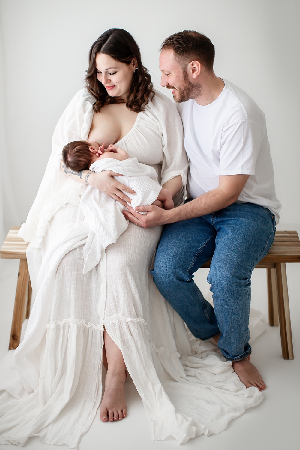 Bromley Newborn Photography | a couple breastfeeding their newborn baby during a newborn photoshoot in Bromley