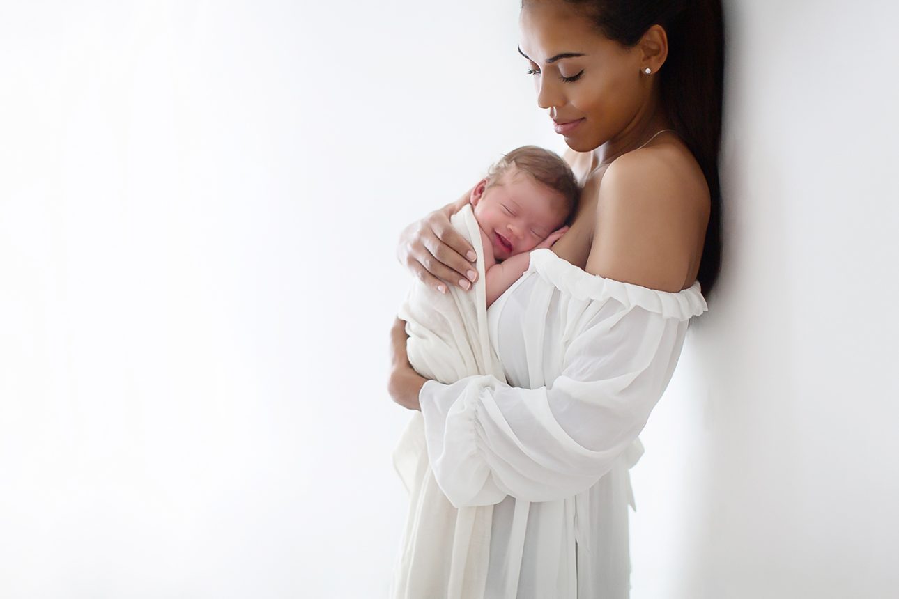 Bromley Newborn Photoshoot | portrait of a mum holding her newborn daughter