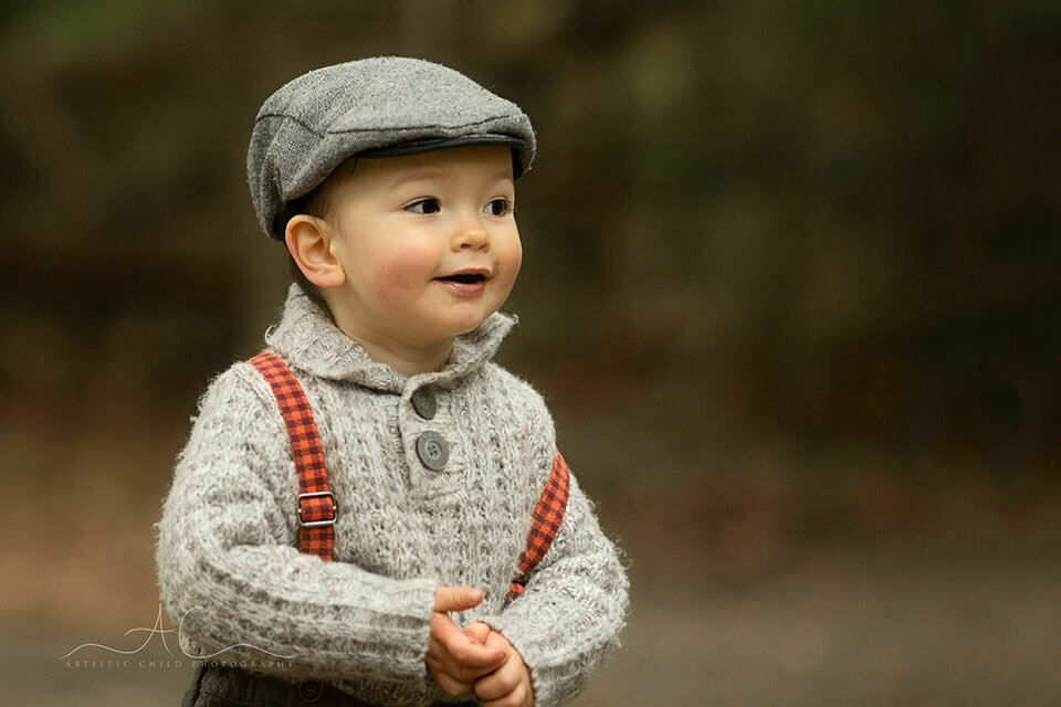 Professional London Toddler Photo Session | Jacob 2 portrait of 18 months old boy wearing a flat cap and trousers with braces | London
