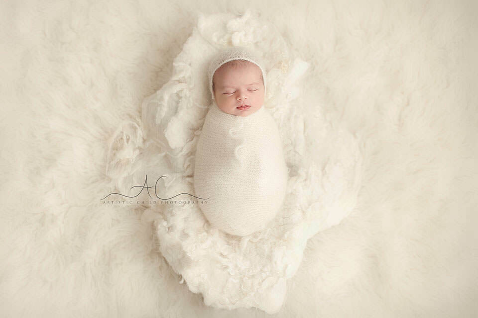 Bromley Newborn Baby Portraits | Ethan 6 Bromley Newborn Baby Portraits | newborn baby boy sleeping swaddled in white knitted swadling blanket lying in wooden trench bowl