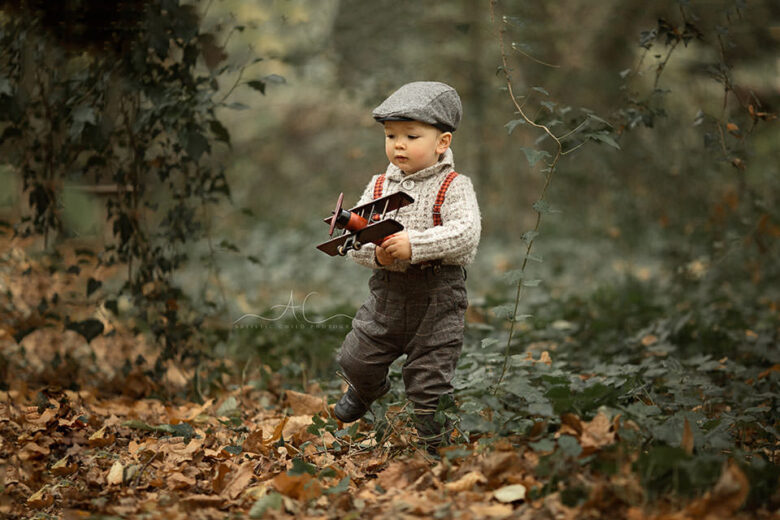 Professional Bromley Toddler Photos | 18 months old boy playing with wooden plane in the park