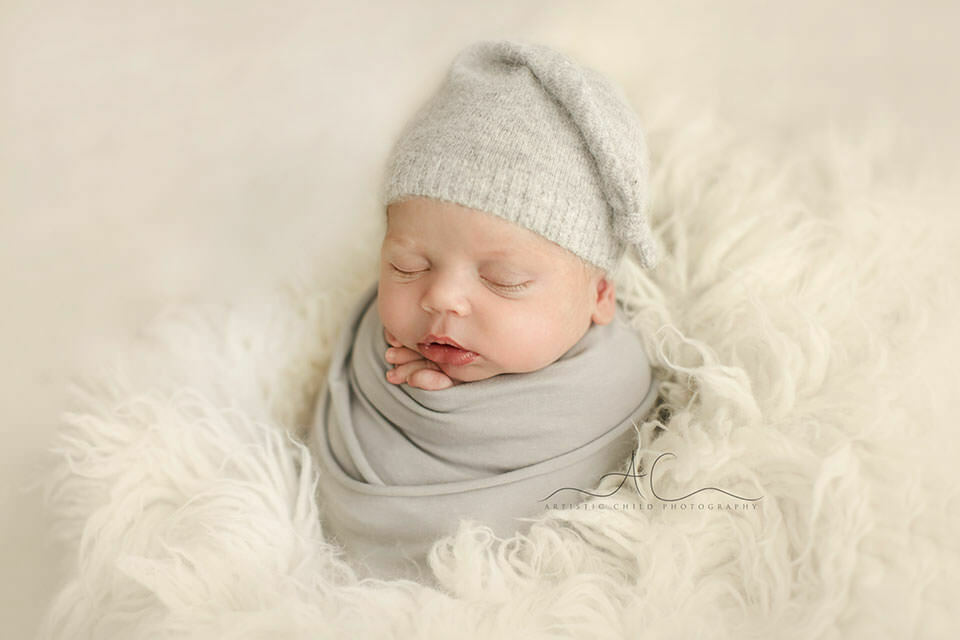 South East London Newborn Baby Boy Images | Finn 7 South East London Newborn Baby Boy Images | portrait of a newborn baby boy wearing a grey cashmire sleepy hat