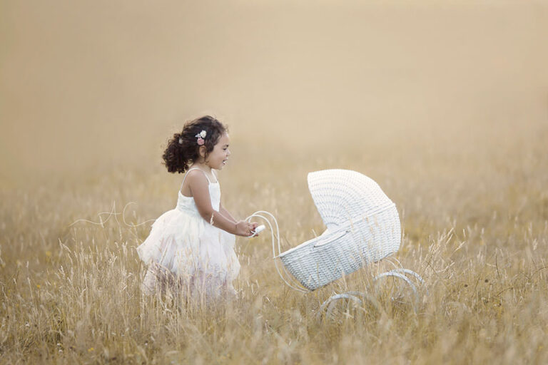 South East London Children Pictures | Martina 6 South East London Children Pictures | 3 year ols girl walking with her pram in the grass field at the golden hour