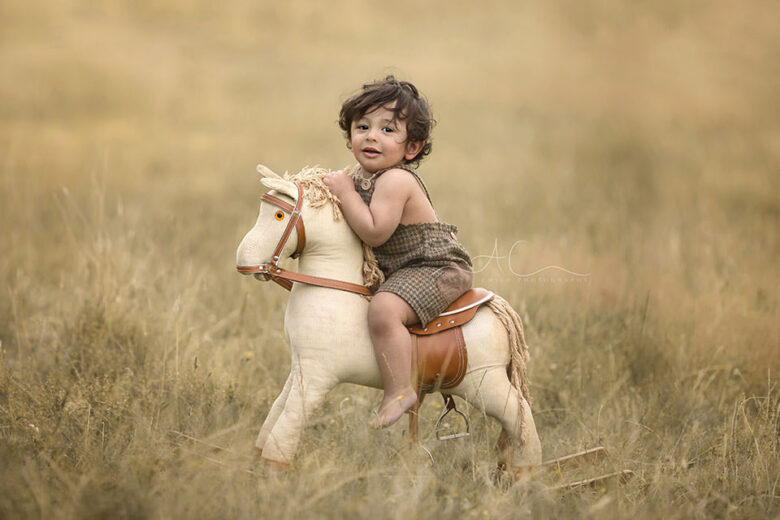 South East London Toddler Photography Offer | 1 year old boy photographed outdoors on the rocking horse