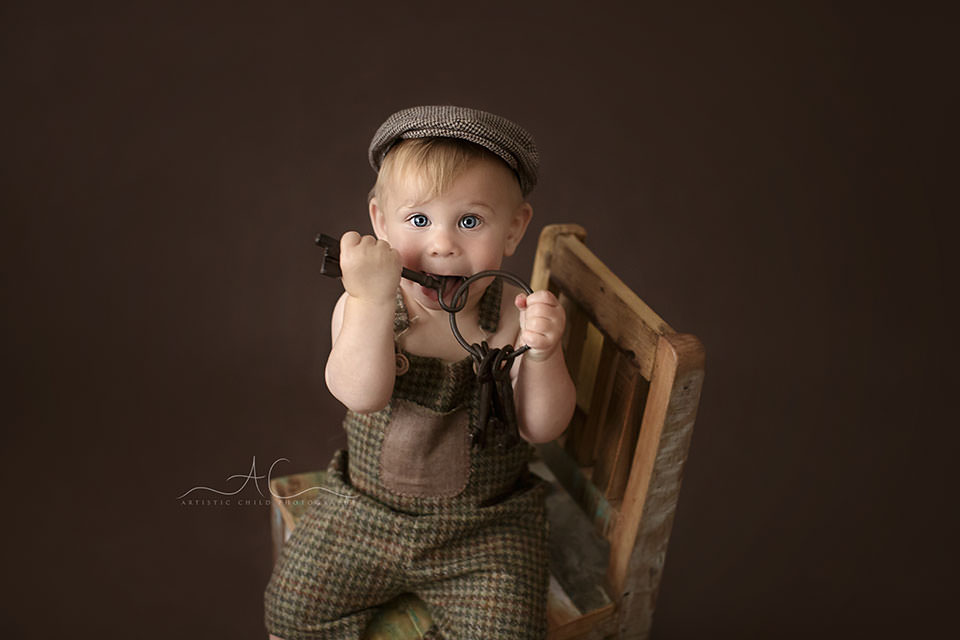 Bromley Toddler Photo Session | Bulcsu 7 Bromley Toddler Photo Session | photo of a 1 year old boy waering a flat cap and playing with a bunch of big metal keys