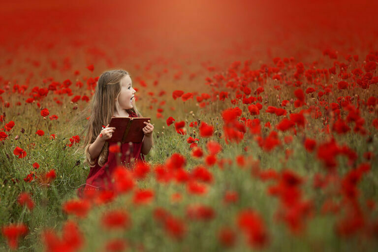 Bromley Children Photos | Nela 4 Bromley Children Photos | 5 year old girl reads the book in the middle of poppy seeds.