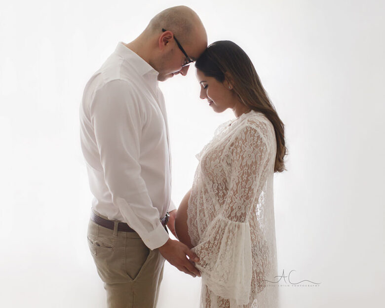 backlit portrait of a couple expecting their first baby | London