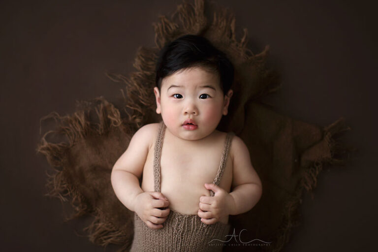 Professional London Baby Boy Photos | Zac 6 Professional London Baby Boy Photos | portrait of a 7 months old baby boy lying on the floor during the professional photo session