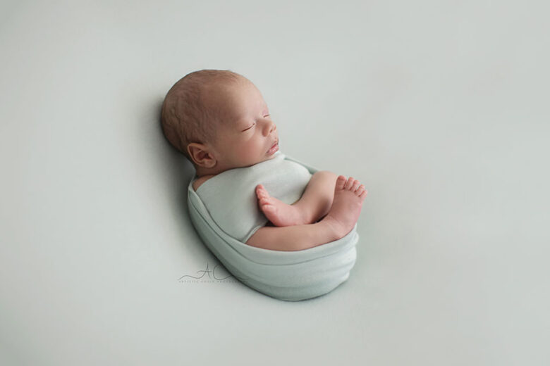 South East London Newborn baby Boy Pictures | backlit portrait of a newborn baby boy photographed on a green backdrop