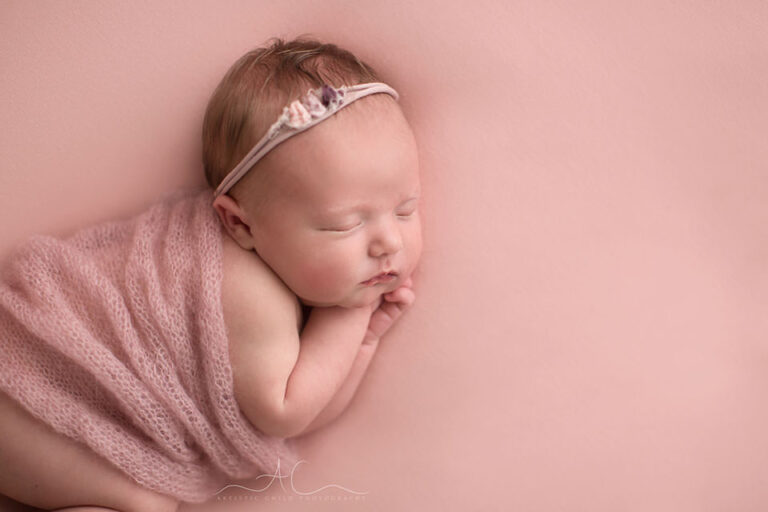 Bromley Newborn Baby Girl Photographer | Penelope 8 Bromley Newborn Baby Girl Photographer | newborn baby girl sleeping on her side covered by a soft hand knitted wrap