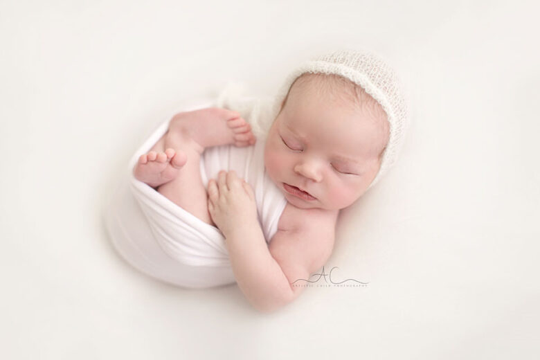 Studio London Newborn Photography | photo of a newborn baby boy wearing a white hand knitted hat
