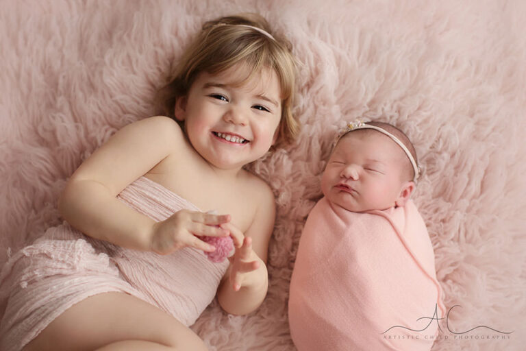 London Sibling Pictures | a portrait of a newborn baby girl and her 3 year old older sister