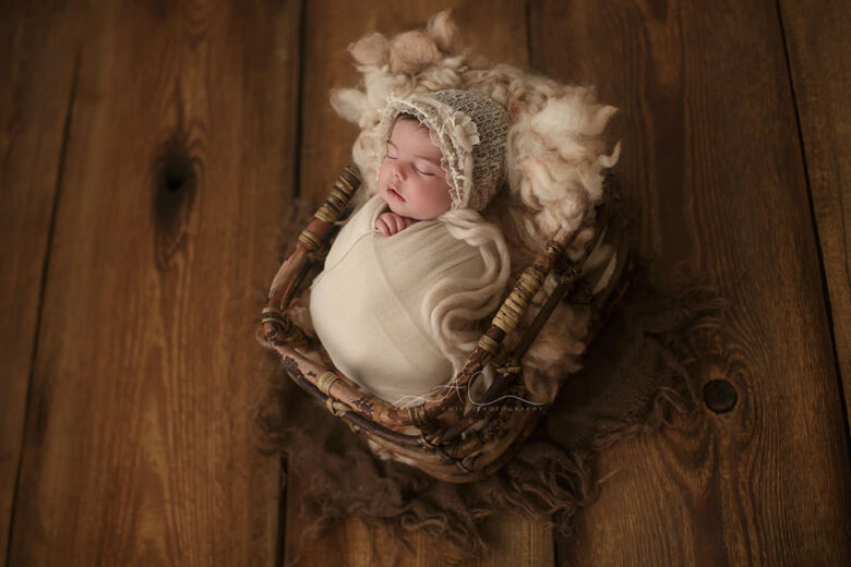 South East London Newborn baby Girl Photography Services | newborn baby girl sleeps in a bamboo basket