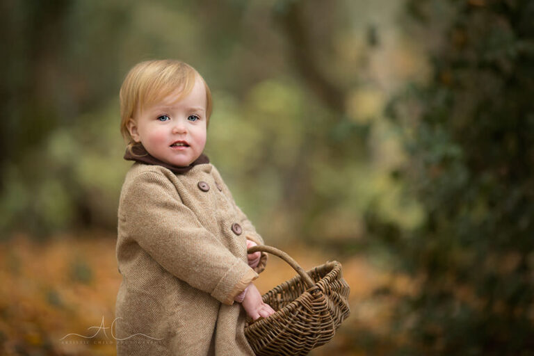 Bromley Toddler Portraits | Freya 4 Bromley Toddler Portraits | 18 months old girl carries a wicker basket in the park during autumn season