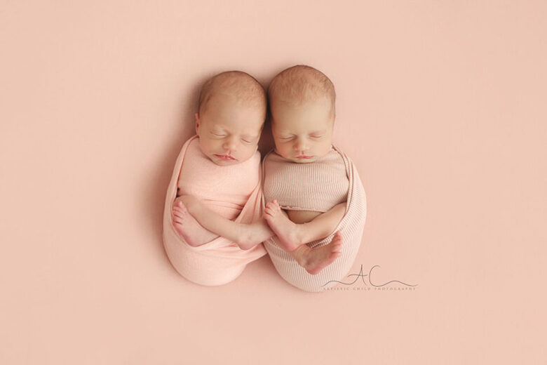 London Newborn Twin Girls Photography | portrait of twin girls swaddled in a pink wrap