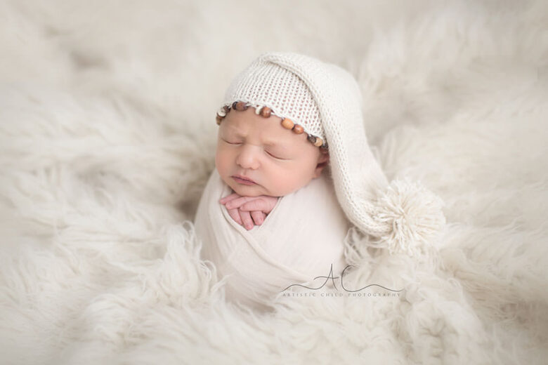 South East London Newborn Baby Boy Photography Offer | portrait of a newborn baby boy wearing a white sleepy hat
