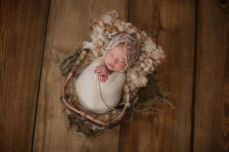 London Newborn Baby Girl Pictures | Evelyn 4 London Newborn Baby Girl Pictures | newborn baby girl sleeps in a bamboo basket during the newborn photo session
