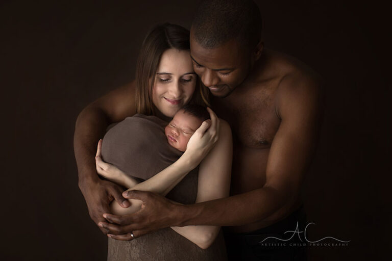 Professional London Family Photo Session | portrait of parents holding their newborn son