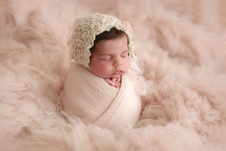 Professional Bromley Newborn Baby Photographer | photo of a newborn baby girl taken on a pink flokati