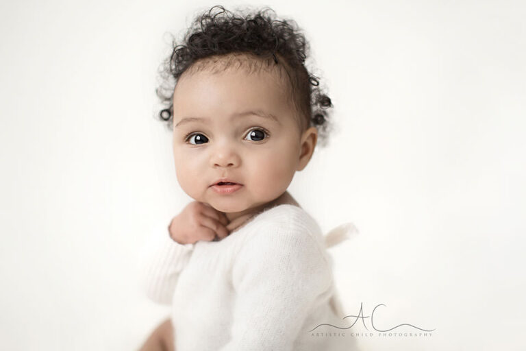 South East London Baby Girl Photo Session | Elena 12 South East London Baby Girl Photo Session | a close up portrait of a cute baby girl with curly hair
