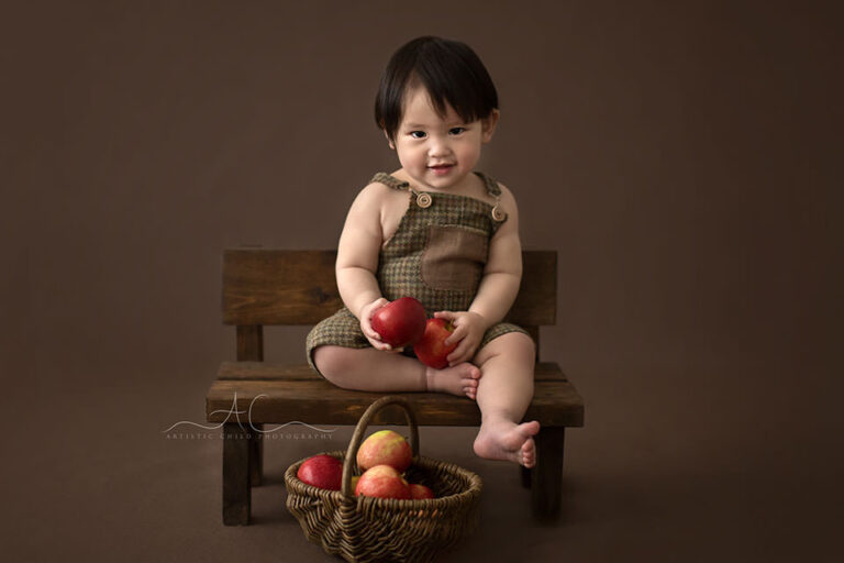 Bromley Child Photos | Soh Chen 11 Bromley Child Photos | portrait of a 1 year old boy sitting on a wooden bench