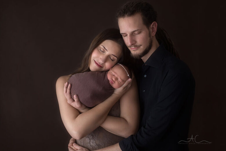 Professional South East London Family Images | parents holding their newborn baby daughter