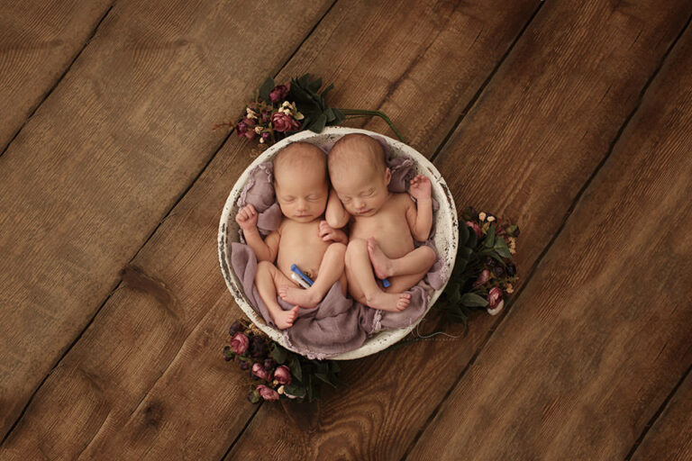 London Newborn Twin girls Photo Session | twin newborn baby girls sleep in the posing bowl during their newborn professional photo session