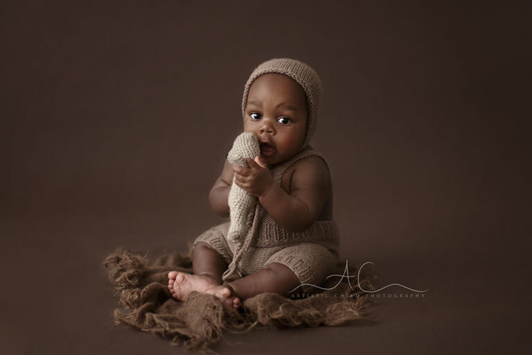 Bromley Baby Boy Photos | Drayson 9 Bromley Baby Boy Photos | baby boy plays with a teddy bear during a professional photo session