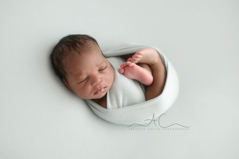 Bromley Newborn Baby Boy Photographer | portrait of a newborn baby boy photographed on a mint background