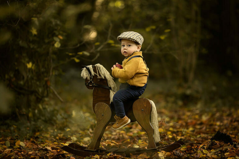 Autumn South East London Toddler Photoshoot 9 Autumn South East London Toddler Photoshoot | outdoor portrait of 15 months old boy sitting on a rocking horse