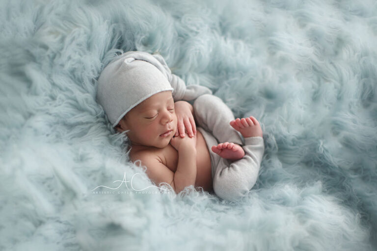 Best South East London Newborn Photographer | backlit portrait of a newborn baby boy wearing a sleepy hat