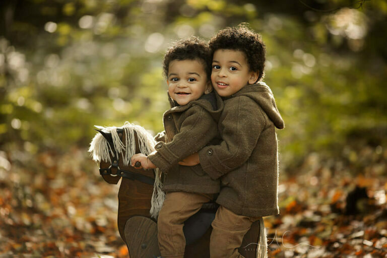 Bromley Autumn Sibling Photography | portrait of brothers on a rocking horse during autumn mini photoshoot