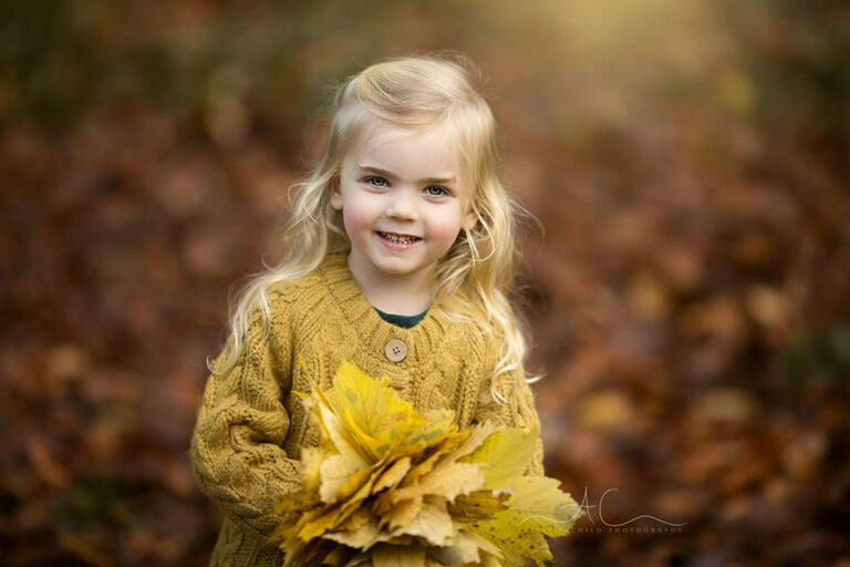 Autumn London Children Photo Session 6 Autumn London Children Photo Session | warm portait of a beautiful 3 year old girl with autumal leafs