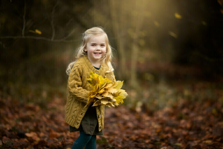 Magical Autumn South London Children Photoshoot | 4 year old girl throwing leaves during an autumn photo session