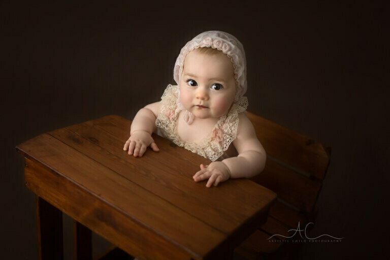 Unique Bromley Baby Photography | Sara 3 Unique Bromley Baby Photography | portrait of a beautiful 7 months old baby girl sitting a an old school desk