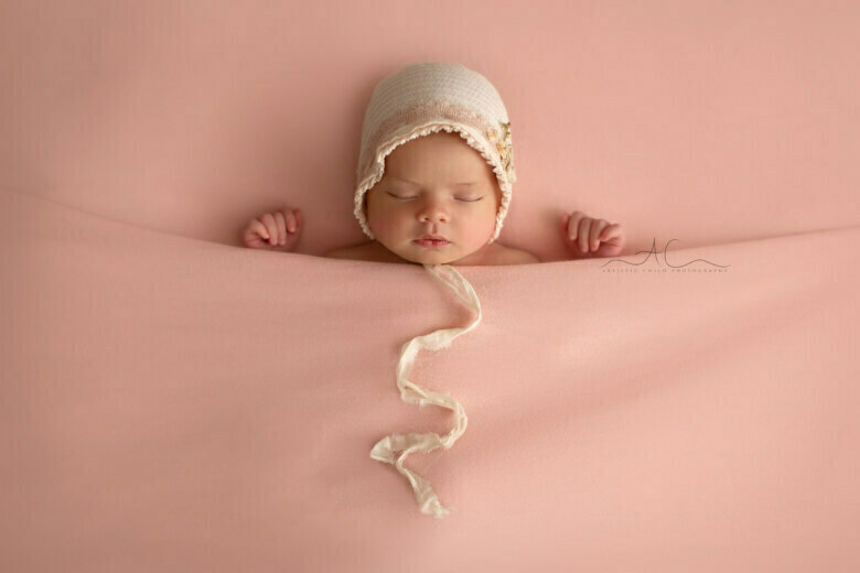 Top South East London Newborn Photo Session | portrait of a newborn baby girl wearing a cute pink bonnet
