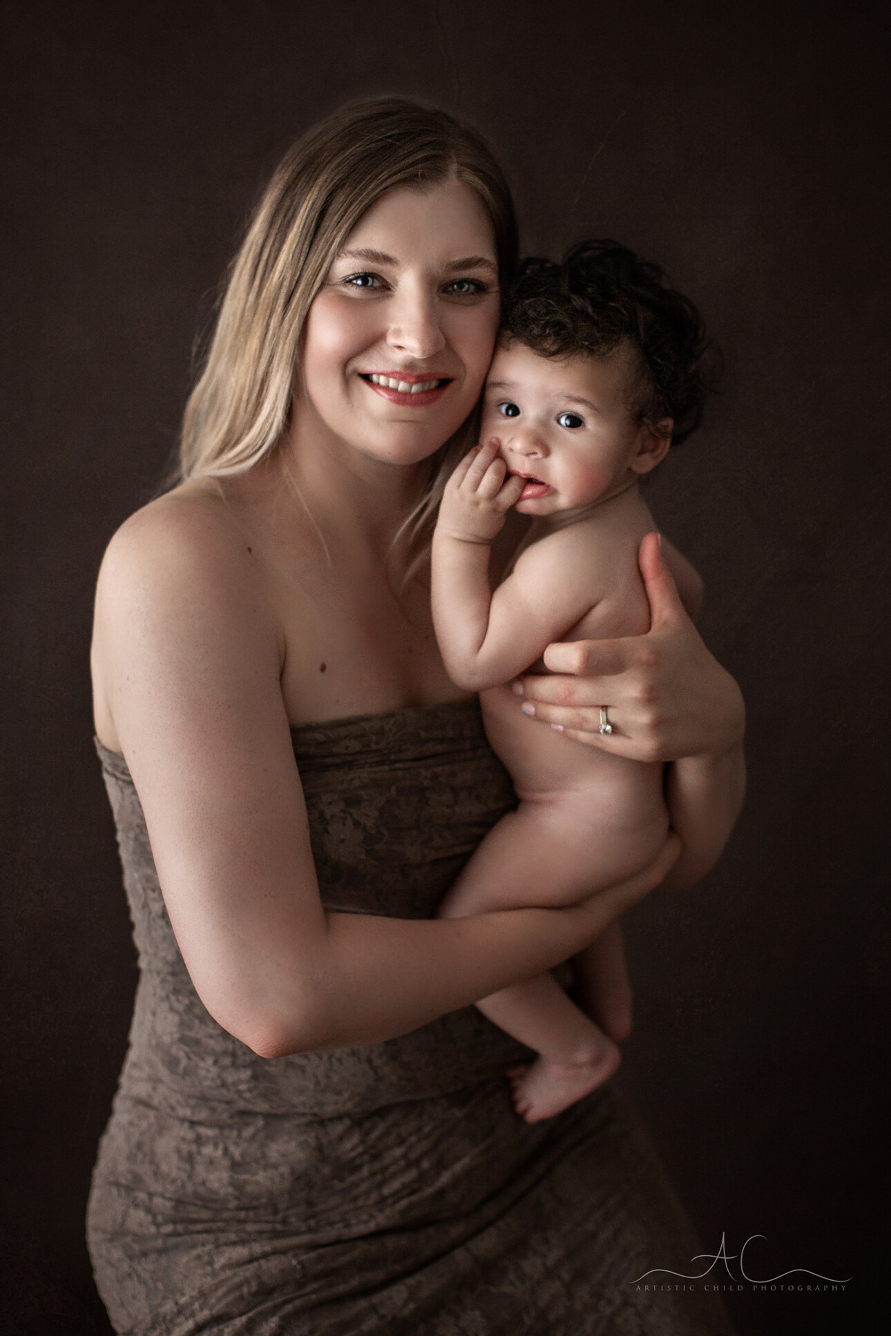 Top South East London Family Portraits | Vincent 4 mother holds her 5 months son during a professional portrait session in South East London studio