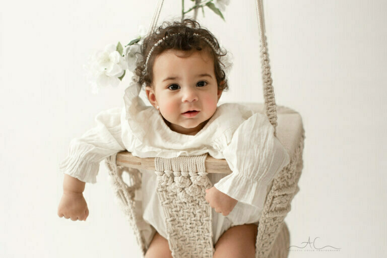 Beautiful South East London Baby Photos | a close up portrait of a baby girl in a macrame swing