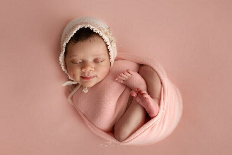Amazing Bromley Newborn Photography | portrait of a newborn baby girl smiling with a cute little dimple